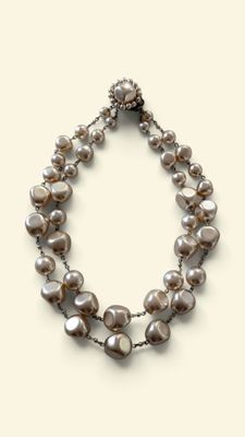pearl and silver necklace on a white background