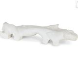 a white figurine of a fish on a white background