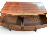 a wooden table with two drawers on top of it