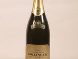 the bottle of champagne is sitting on a white surface