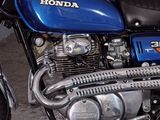 a blue motorcycle that is parked in a garage
