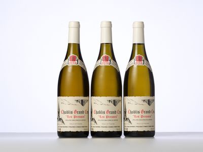 trois bouteilles de vin posées sur une table blanche