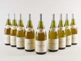 six bottles of wine lined up in a row on a white surface