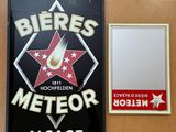 a sign and a plaque on the wall of a restaurant