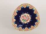 a close up of a plate with a flower design on it