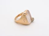 a close up of a gold ring with a stone in the middle
