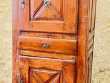 a wooden cabinet with a door on top of it