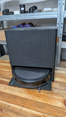 a black stove sitting on top of a wooden table