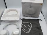 a box of headphones sitting on a table next to a pair of earphones