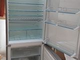 an open refrigerator with its door open in a kitchen