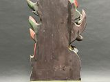 sculpture of a horse head with a green stripe on a wooden base