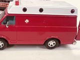 a red toy truck with a white top and a white roof