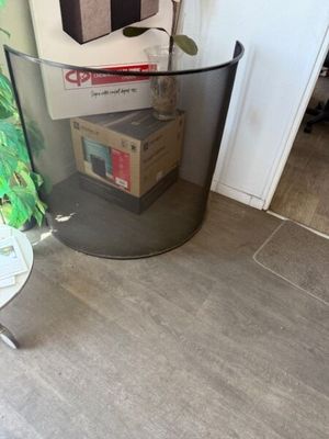 a glass table with a box on it next to a plant