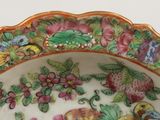 a colorful plate with birds and flowers on it