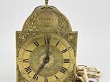 a gold clock with a rope around it
