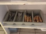 a shelf that has a bunch of utensils in it