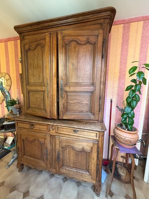 un grand meuble en bois dans le coin d'une pièce