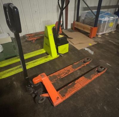 two forklifts sitting next to each other in a warehouse