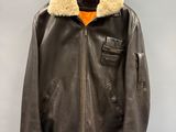 an image of a brown leather jacket hanging on a hanger