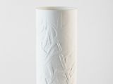 a white table lamp that is on a table