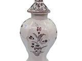 a white vase with a brown and white design on it