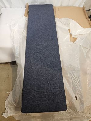 a blue carpet on top of a bed in a room