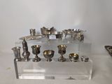 a display of silver objects on a clear shelf