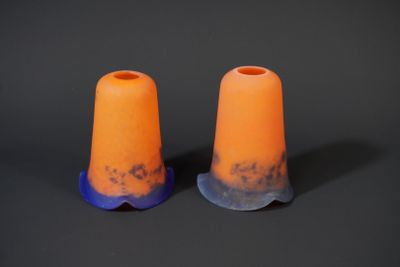 pair of orange and blue plastic cones sitting on top of a black surface