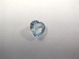 a heart shaped aquamarine blue topaz gems on a white surface