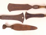 three old wooden knives sitting next to each other on a white surface