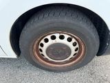 a white car with a flat tire that has holes in it