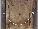 an old picture frame with a rope hanging from it ' s side