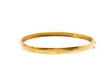 a close up of a gold ring on a white background