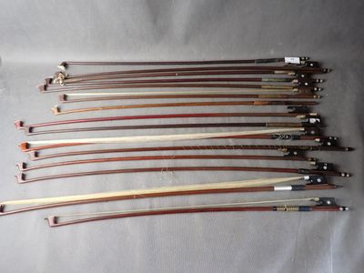 a group of six wooden and metal bows sitting on top of a white sheet