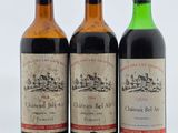 trois bouteilles de vin posées l'une à côté de l'autre sur une table