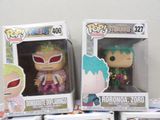 three pop vinyl figures of anime characters in boxes on a table