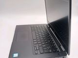 a laptop that is open on a white surface