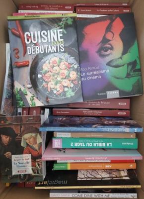 many books in a cardboard box on the table