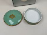 a small bowl with a lid that has a crown on it
