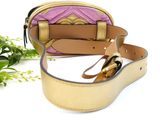 a purse and a pair of scissors on a white surface