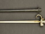 a close up of two swords on a table next to each other