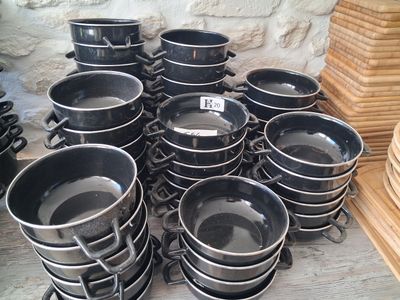 many pots and pans that are sitting on a table