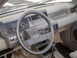 a steering wheel and dashboard of a car with a clock on it