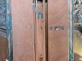 a wooden cabinet with a door open on a table