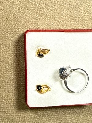trois bagues dans une boîte rouge posée sur un fond beige