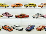 a lot of toy cars that are on a shelf