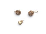 two pairs of gold earrings and a gold earring