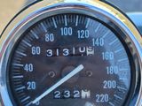 a close up of a speedometer on the handlebar of a motorcycle