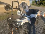 a white atv with a black seat parked in a parking lot