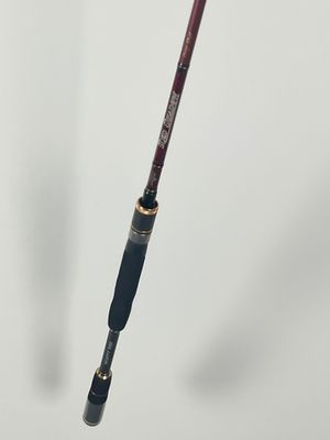 a close up of a fishing rod on a white surface